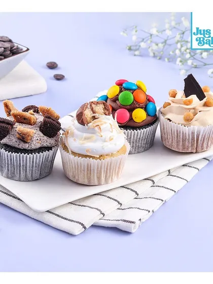 Another one of our delicious cupcake assortments. This box features a variety of toppings like M&Ms, Oreo cookies, and Snickers, making it a fun and tasty treat for any occasion.