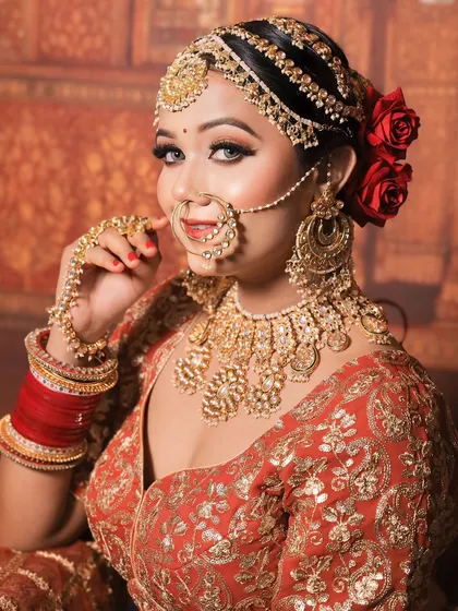 Another stunning portrait of the bride in her golden jewellery, showcasing the complete set from a different angle.