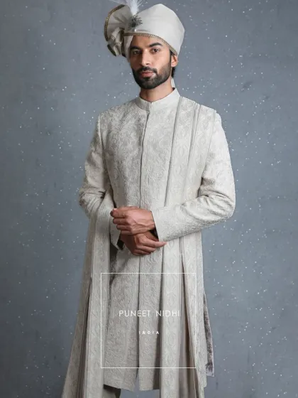 In the quiet elegance of ivory lies a reflection of Indian weddings. This jacquard sherwani, with its hand-finished details and bandhgala collar, is woven not just as an attire, but as a memory to be cherished.