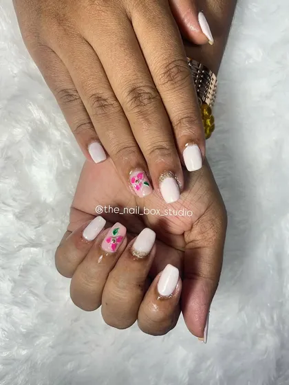 A simple and clean look on natural nails. I used a soft white gel polish as the base and added a pop of color with this hand-painted 3D flower art using carving gel.