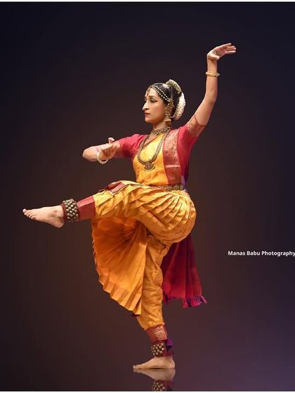 A classic Kuchipudi pose captured in a studio setting, highlighting the form and grace of the style.
