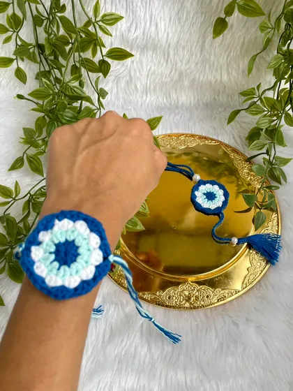Showing the Rakhi tied on a wrist to demonstrate how it looks when worn.