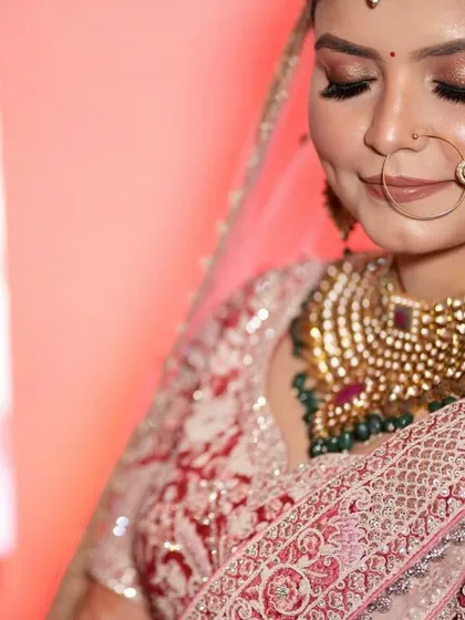 A close-up on the bride's dimpled smile, her jewellery adding to her radiant glow.