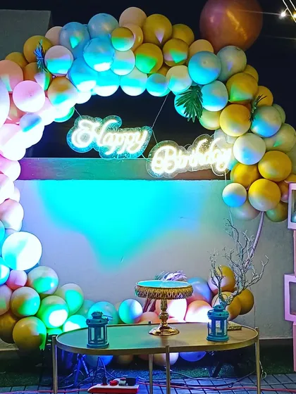 A different lighting angle on the surprise party decor, showing how versatile the setup can be. The pink and gold tones create a warm and celebratory feel.