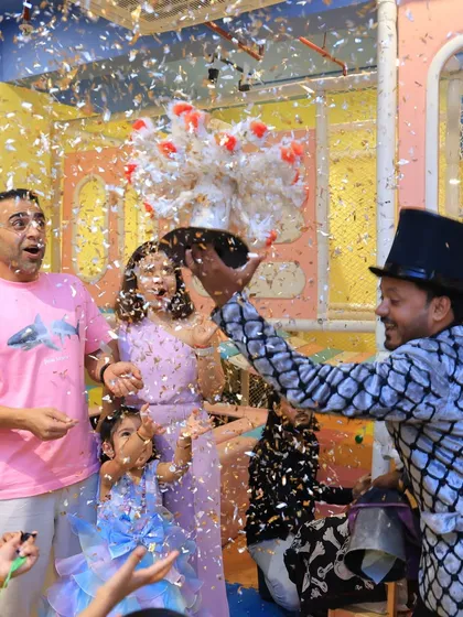 Our magic shows are a highlight for kids and parents alike. We work with talented magicians who perform captivating tricks, like this surprising flower and confetti reveal, that leave the whole family amazed and delighted.