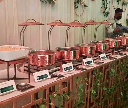 A professional buffet setup for a Diwali party, featuring a custom-designed counter and elegant copper serving dishes. My team ensures a seamless and high-quality service experience.