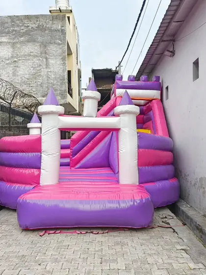 A princess castle-themed bouncy in pink and purple. This design features multiple turrets and a slide, perfect for fairytale-themed parties.