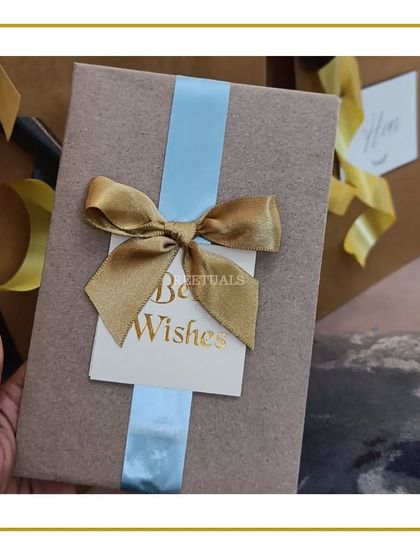 A simply wrapped gift with a 'Best Wishes' card, part of a larger anniversary surprise.
