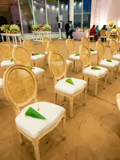 The elegant seating arrangement for a ceremony, with cones of flower petals placed on each chair for the guests.