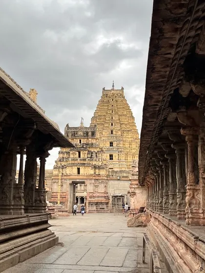 The majestic Virupaksha Temple, the oldest and principal temple in Hampi, as seen through its ancient stone corridors.