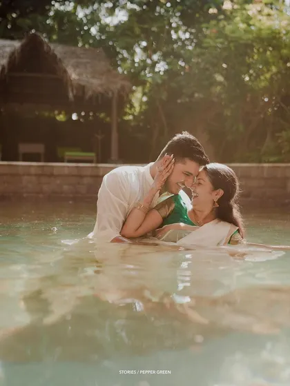 An intimate and romantic portrait of the couple in the water of a temple pond.