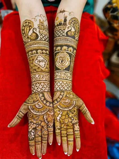 This design combines traditional peacock and temple motifs with modern skyline art, including the Statue of Liberty, and the bride's name 'Tanaya'.