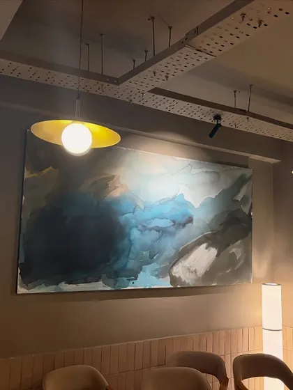 My art isn't just for homes. I love creating large, statement pieces for commercial spaces like this 8ft x 4ft fluid abstract painting for a cafe in Lucknow, designed to create a unique and memorable atmosphere for their customers.