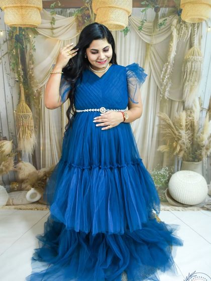 A lovely portrait of a mom-to-be in a royal blue gown, taken in our boho studio setting.