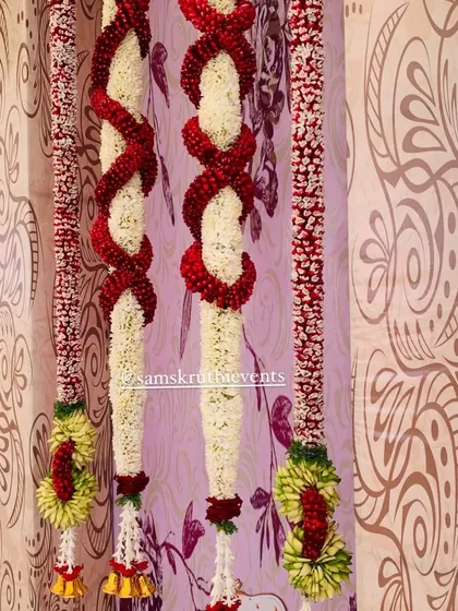 A detailed look at my custom-made 'diamond cut' flower garlands. The intricate weaving of red and white flowers shows the high level of skill my team brings to every event.