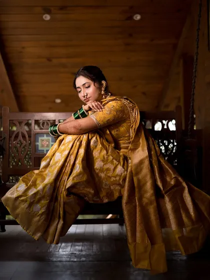 Another stunning shot on the swing, capturing the full flow and richness of her Nauvari saree.