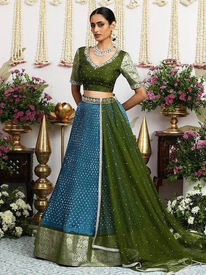 Another angle of the teal and green lehenga, capturing the flow of the pleated silk skirt.