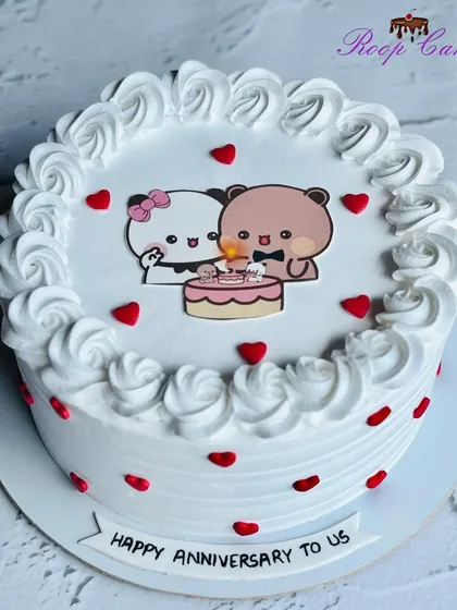 A cute half-kg anniversary cake featuring adorable cartoon bears celebrating together.