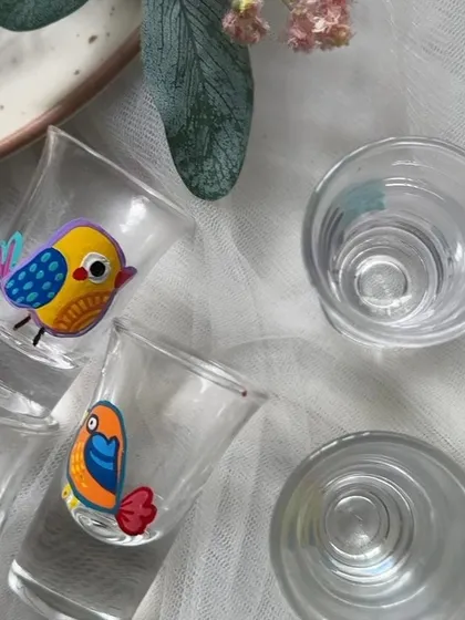 Another angle of the bird-themed shot glasses, showing their fun and colorful designs.