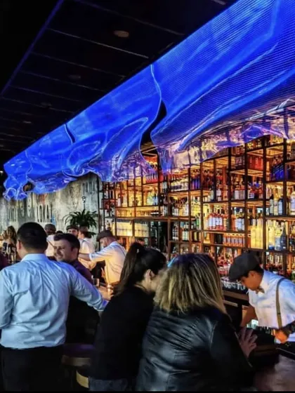 A lively evening at the LokalJC bar. We designed the space to be energetic and social, with a long bar that encourages interaction and a vibrant atmosphere.