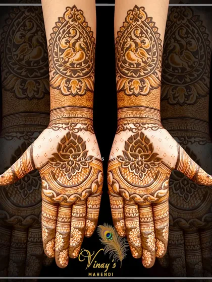 A classic symmetrical design with lotus motifs on the palms and peacocks on the wrists, perfect for guests who love traditional art.