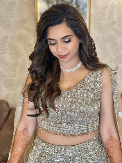 A close-up of the eye makeup, featuring a beautiful blend of silver and taupe shimmers that make her eyes sparkle.