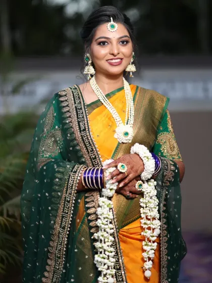 A full view of the baby shower jewellery set. It includes a long necklace, hathphool with kalire, jhumkas, and a maang tika, all made with fresh mogra and accented with green details.