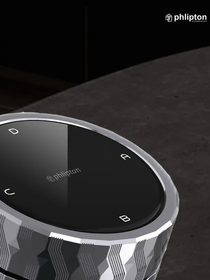 A close-up of the smart knob shows the clear icons for different scenes. The textured metal finish and polished top make it a statement piece of technology for any modern home.