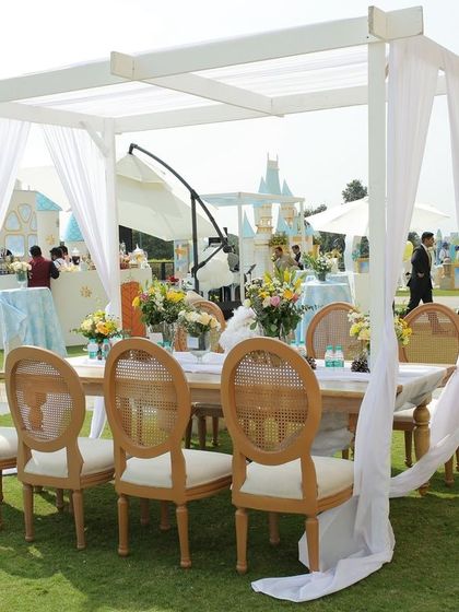 Elegant dining setup at the Winter Wonderland first birthday party. The white canopies and classic wooden chairs create a sophisticated yet comfortable atmosphere for guests.