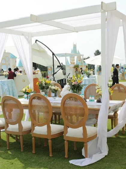 An elegant 'Winter Wonderland' first birthday with castle props and draped cabanas.