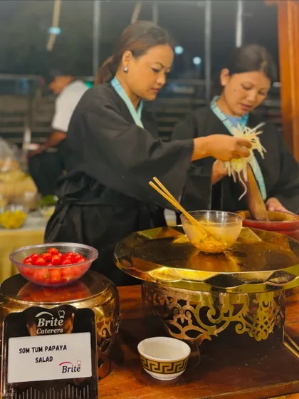 A close-up of the live papaya salad preparation, showcasing the fresh ingredients and authentic technique.