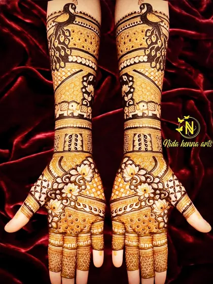 This Indian design starts with a beautiful peacock at the top of the arm. The pattern flows down to include small elephant figures and floral jaal work on the palms.