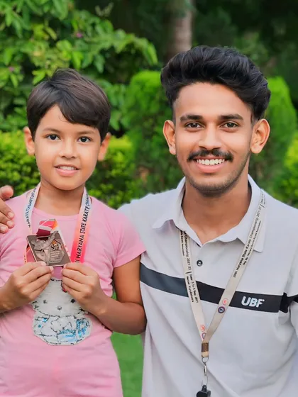 A young fighter proudly displaying her medal from the Haryana State Karate Championship. Her journey is just beginning.