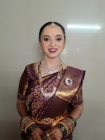 A full view of the radiant look for her post-wedding pujani ceremony. The makeup is designed to look fresh and timeless, ensuring she looks perfect both in person and in photographs.