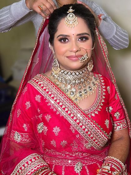 A behind the scenes shot of the final touches on Divya's hair and dupatta. I make sure every single detail is perfect before the bride steps out.