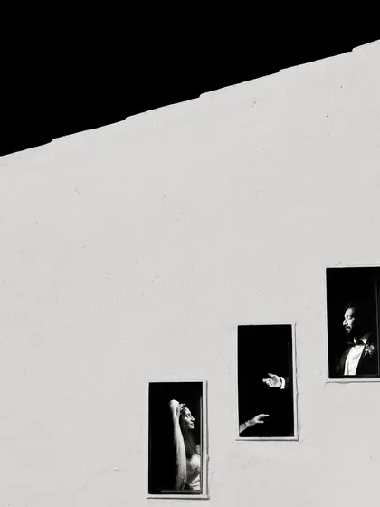 This award-winning shot is all about minimalist composition. I used the stark lines of the building and the small windows to create a story of connection and distance, proving that powerful portraits can be found in the simplest of elements.