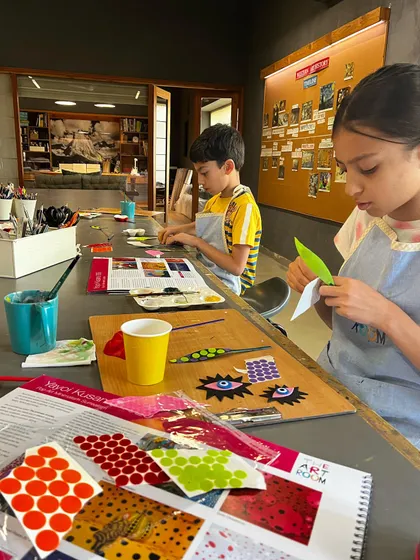 Students work on a project inspired by Yayoi Kusama, using dots and patterns to create their art.