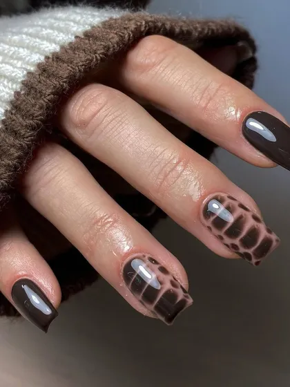 A finished look of the crocodile skin nail art in a rich brown color, perfect for an edgy, fashionable statement.
