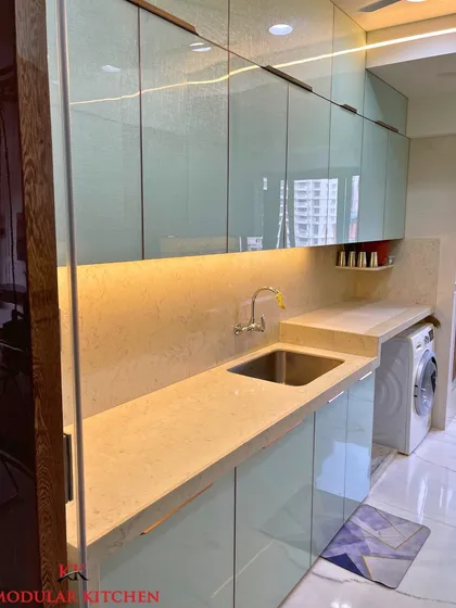 A closer look at the textured back-painted glass finish on the cabinets of our Ghatkopar project. The subtle texture adds depth and character to the kitchen's design.