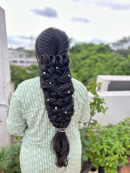 The full view of the stunning, sculptural braid, perfect for a hairstyling competition or a high-fashion bridal look.