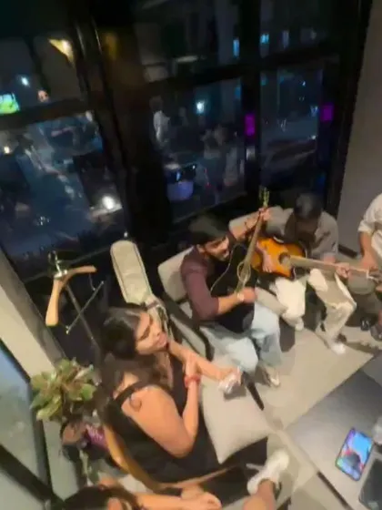 An intimate music jam session, with people gathered close, enjoying the acoustic vibes. This is where real connections happen.