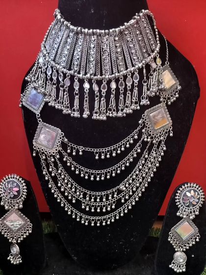 A layered oxidised silver necklace set with square-shaped colorful stones, perfect for a bohemian look.