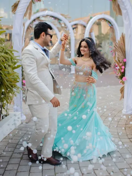 Capturing a joyful moment as the couple dances amidst bubbles, adding a touch of magic to their carnival celebration.