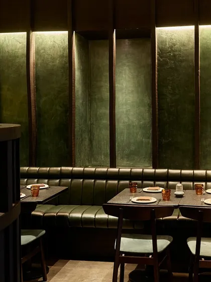 For the Otra restaurant in Mumbai, we created a moody and intimate atmosphere. This booth features deep green leather and textured walls, with carefully controlled lighting to craft a dramatic dining experience that feels like a world away from the city outside.