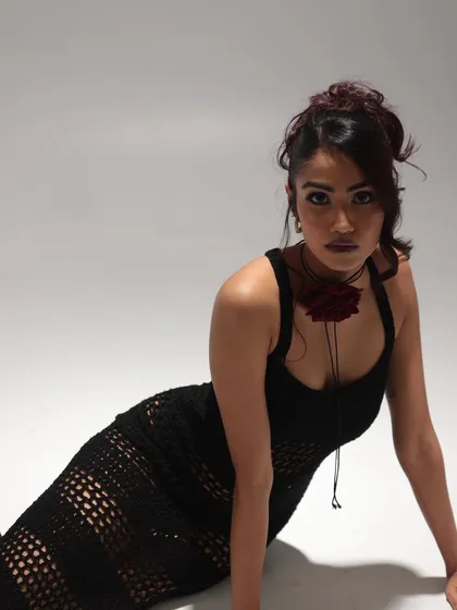 An edgy yet romantic look featuring a dark smokey eye and a textured, messy updo. The style is perfect for fashion editorials that aim for a moody and sophisticated vibe.