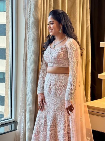 A profile view showcasing the elegant hairstyle and how the makeup complements it perfectly for a complete sangeet-ready look.