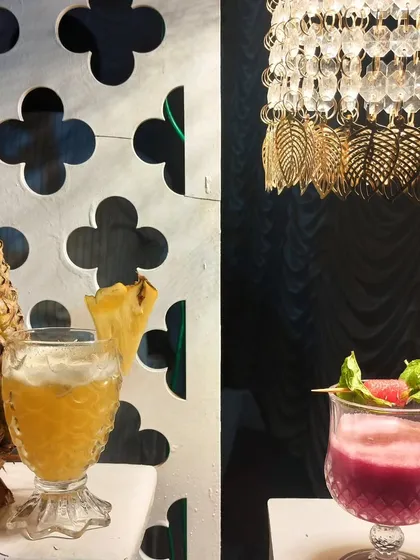 We focus on fresh ingredients and beautiful presentation. On the left, a refreshing pineapple-based drink, and on the right, a vibrant watermelon and basil mocktail, each perfectly garnished.