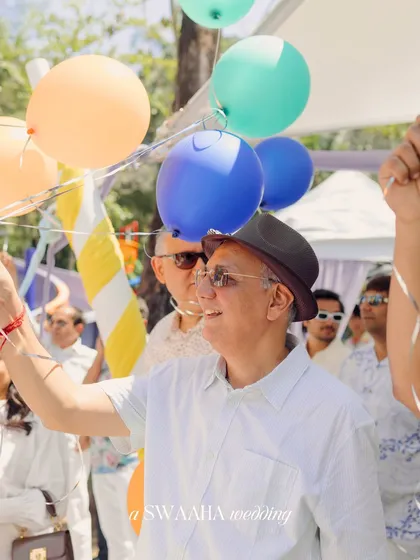 A guest holding colorful balloons, ready for a celebratory release, capturing a moment of simple joy.