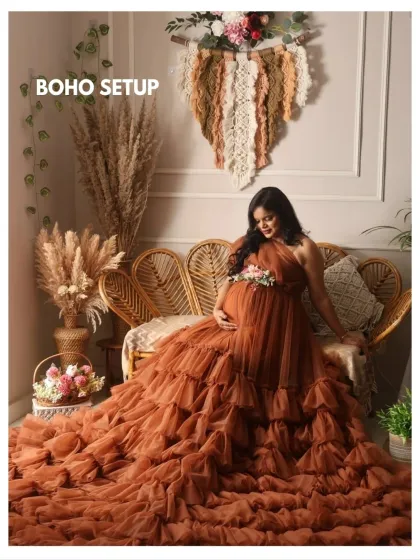 A beautiful example of my boho setup, featuring a stunning ruffled gown in a rich, earthy brown color. The rattan sofa and macrame wall hanging complete the look.
