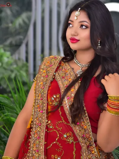 A profile shot that highlights the model's features and the details of her traditional jewelry. This angle provides variety and depth to a portfolio collection.